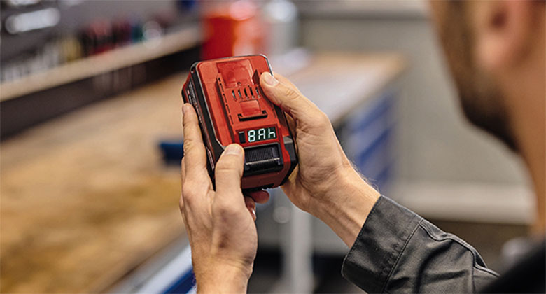 a man is holding the Einhell Multi-Ah battery