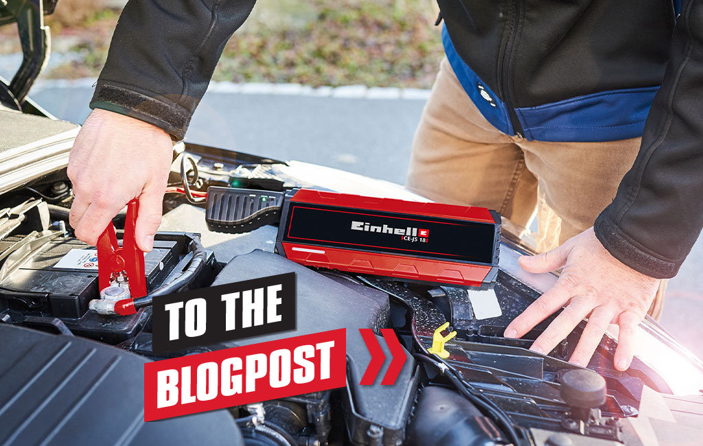 A person uses an Einhell jump starter to start a car, with the caption "To the blog post" in the foreground.