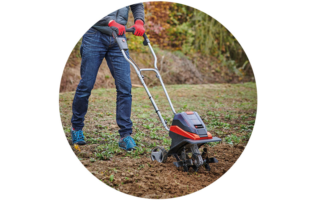 A man works with the Einhell tiller.