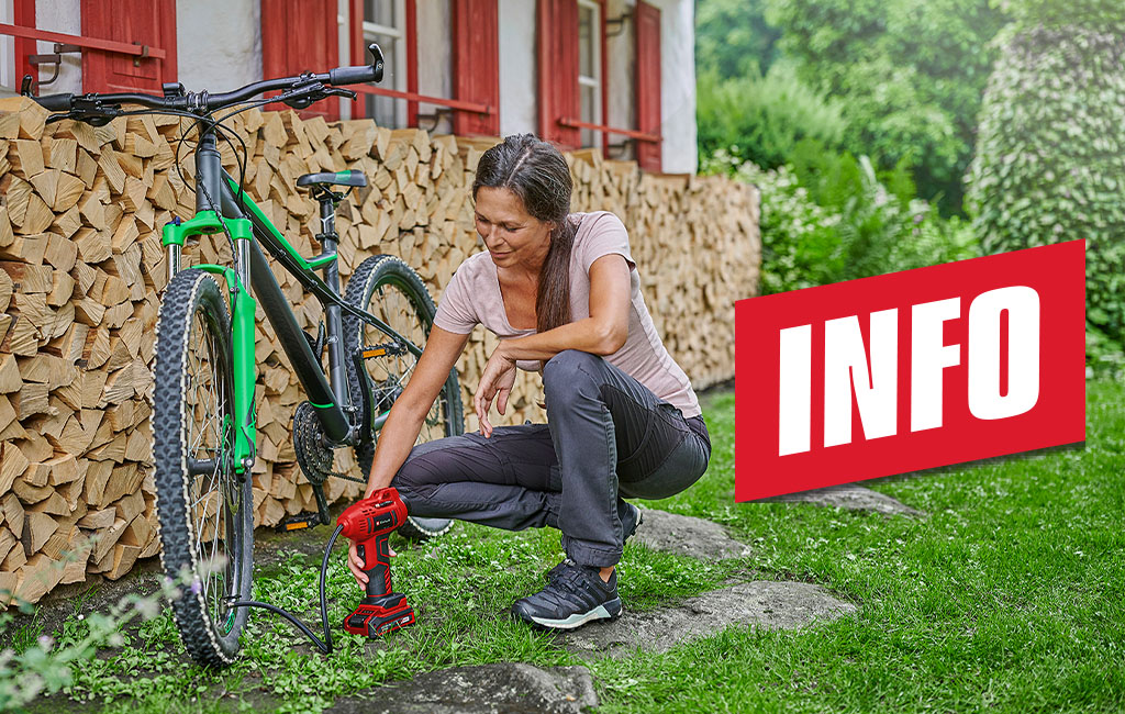 a woman pumps up the tyres of a bicycle