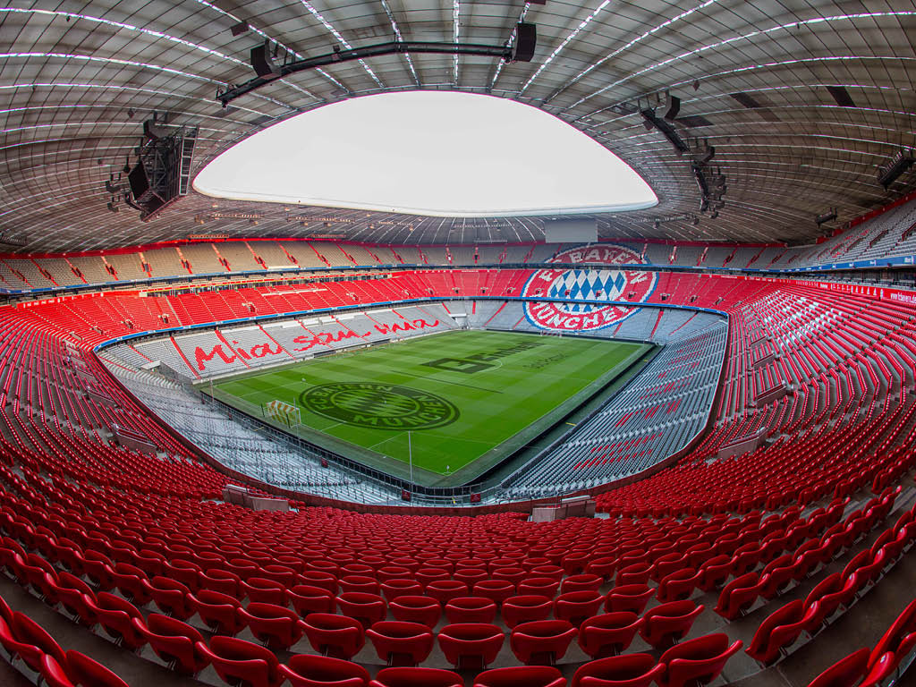 Allianz Arena from the inside with FC Bayern logo and Mia san Mia saying in the row of chairs