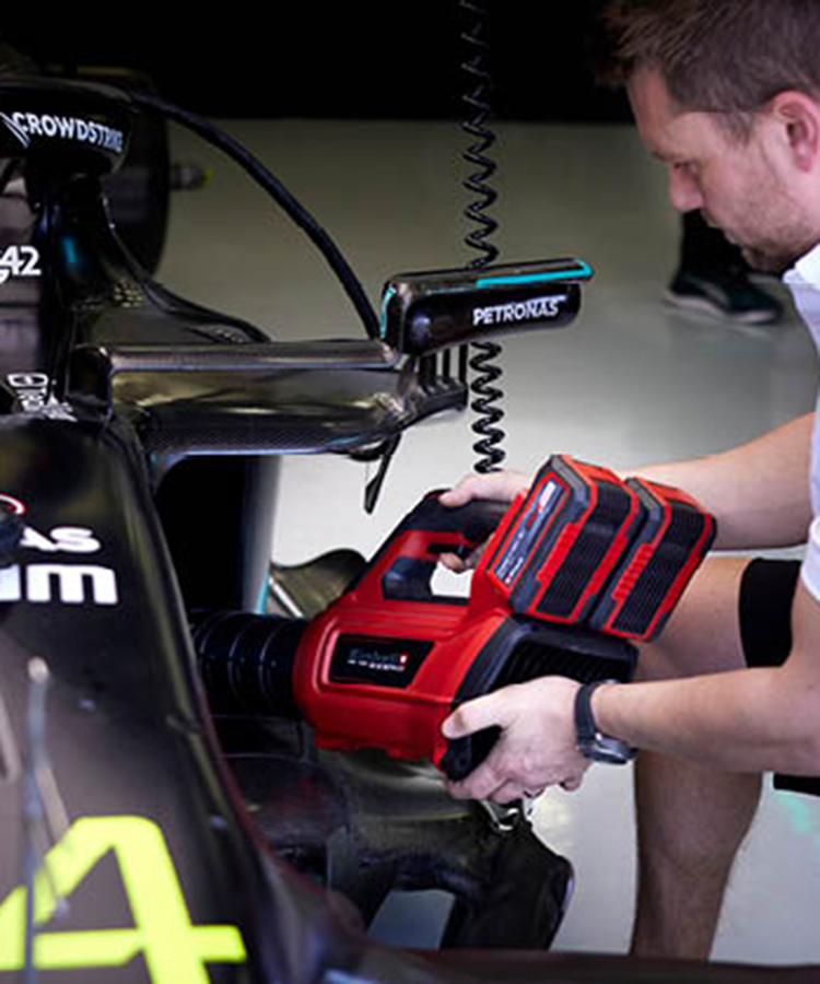 Mercedes Formula 1 car is blown clean with a leaf blower