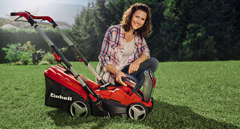 woman with cordless lawn mower